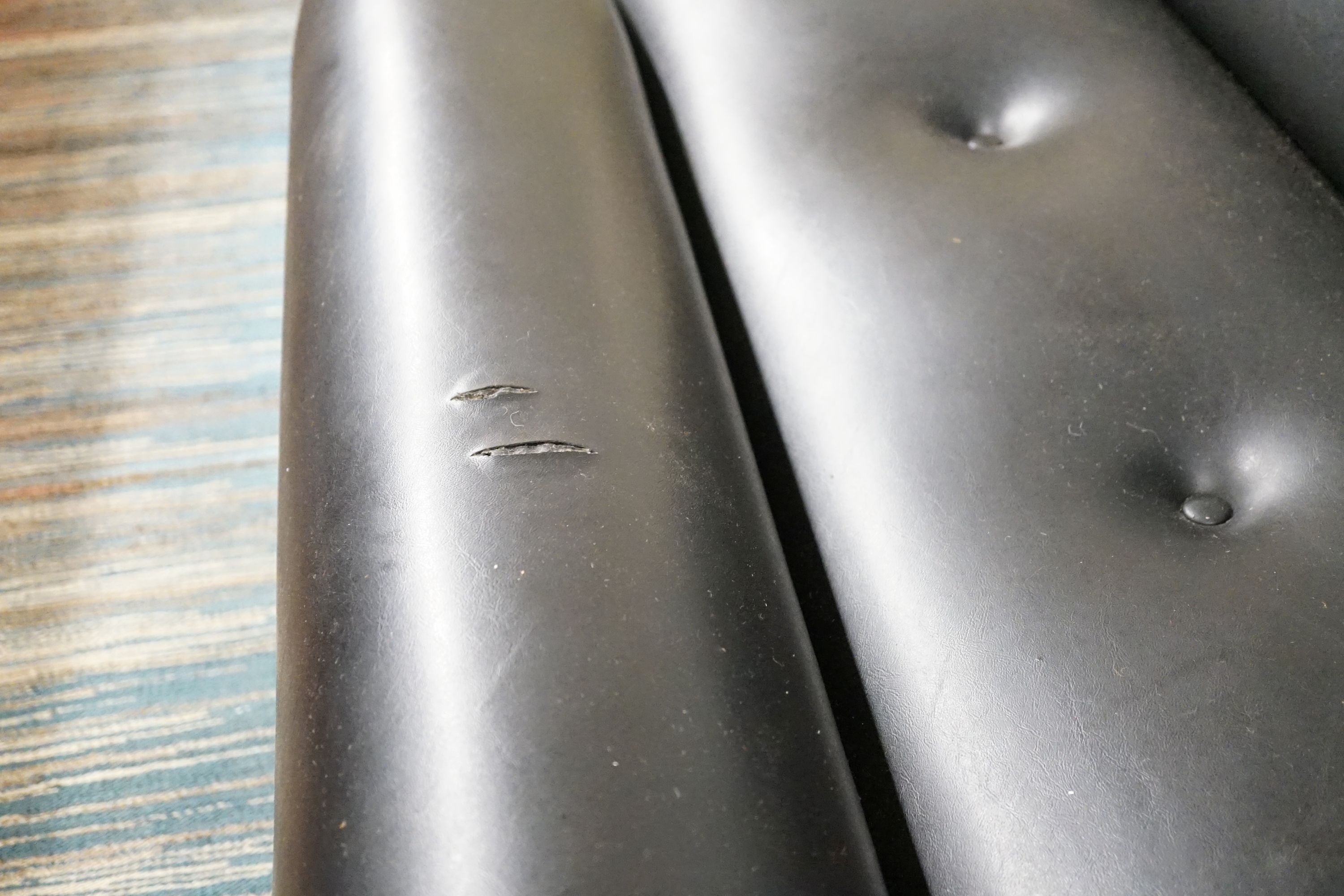 A stylish black vinyl and chrome buttoned settee, length 183cm